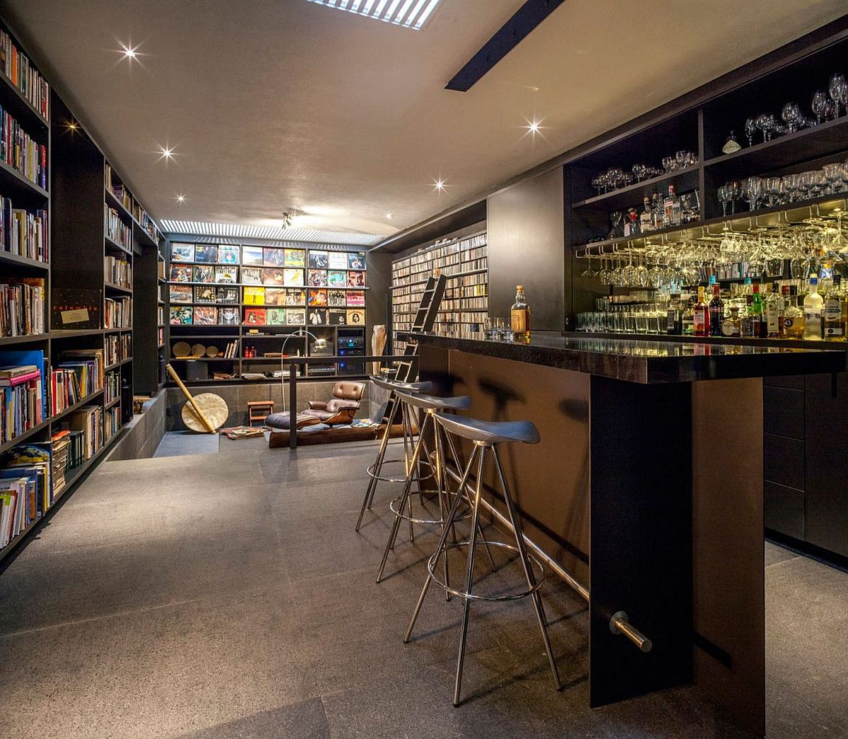 Art-work-wall-of-books-and-a-home-bar-shape-an-intimate-interior.jpg